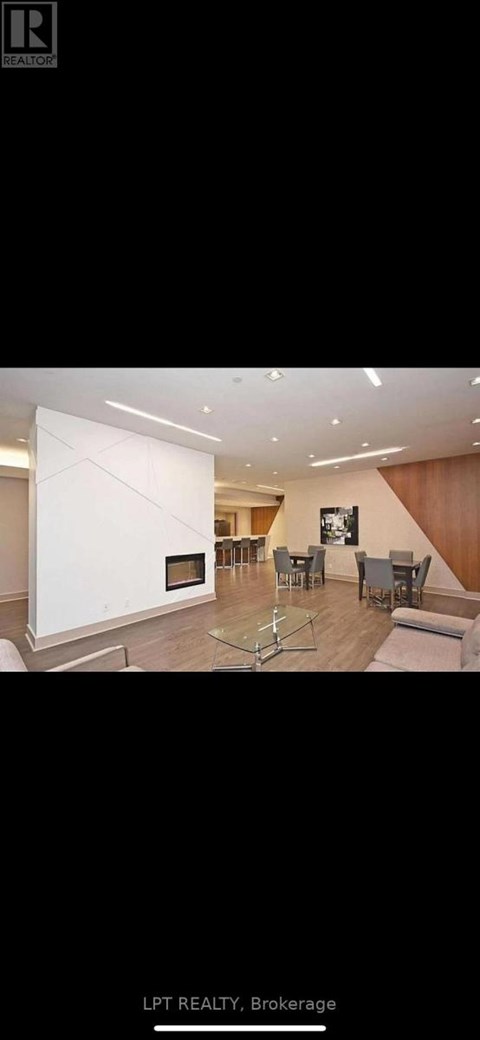 A modern living room with a fireplace and a large painting on the wall.