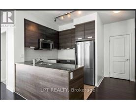 A modern kitchen with a stainless steel refrigerator and microwave.