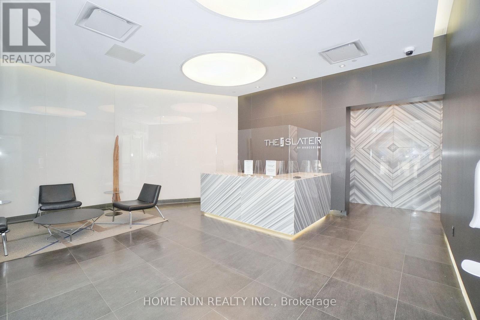 A reception area with a desk and chairs.