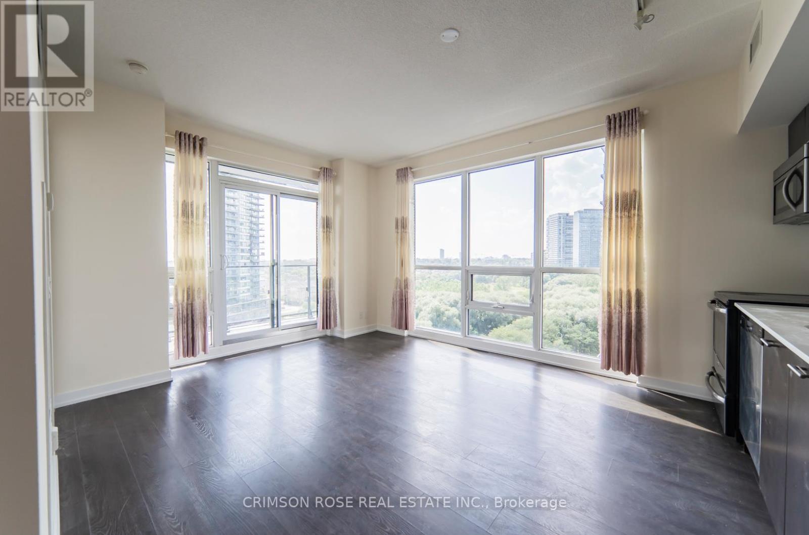 A spacious living room with a view of the city.