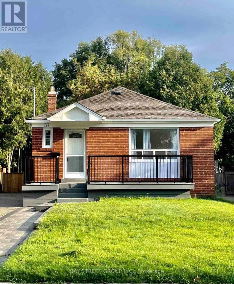 A small red brick house with a white door and a small porch.