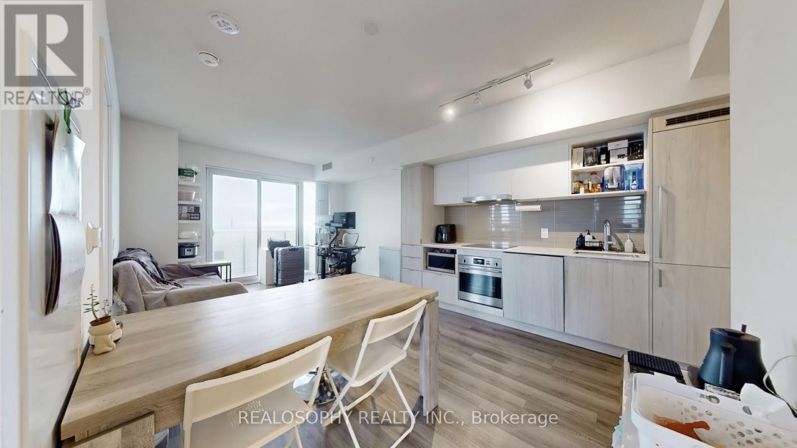 A modern kitchen with a dining table and chairs.
