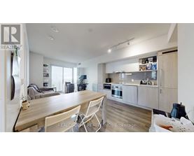 A modern kitchen with a dining table and chairs.