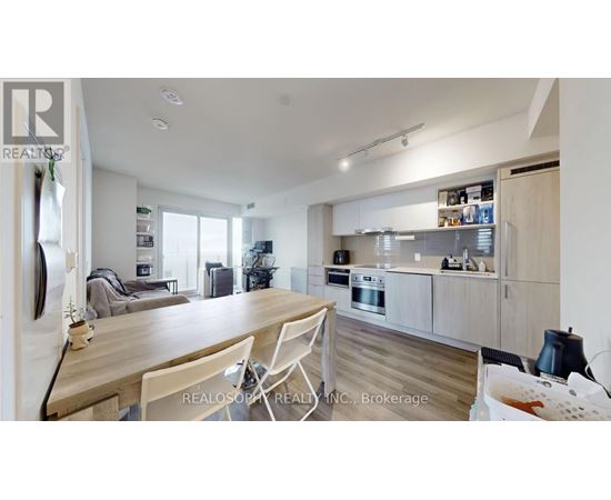 A modern kitchen with a dining table and chairs.