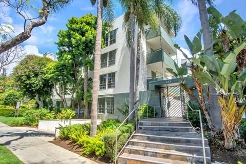 A building with a green lawn in front.
