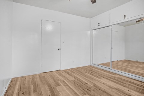 A room with a wooden floor and white walls.