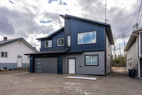 A modern house with a garage and a driveway.