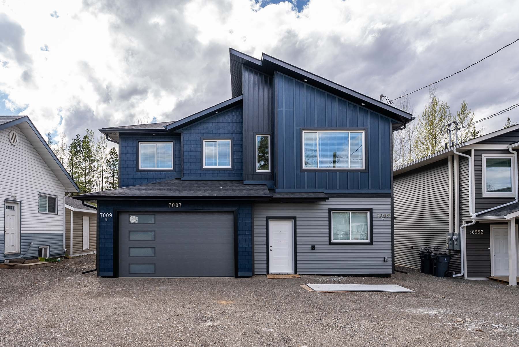 A modern two-story house with a garage.