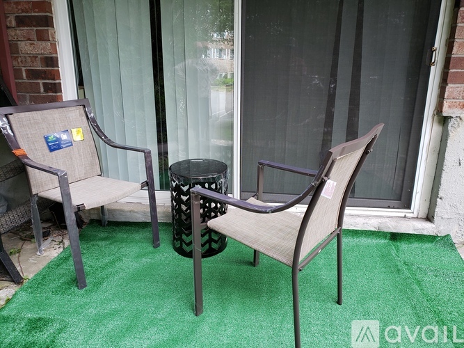 A patio with a chair and a table.