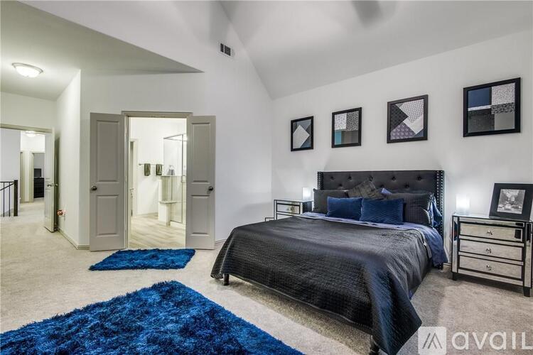 A bedroom with a large bed and a mirror on the wall.