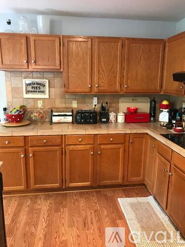 A kitchen with wooden cabinets and a sign that says "fresh baked pies".