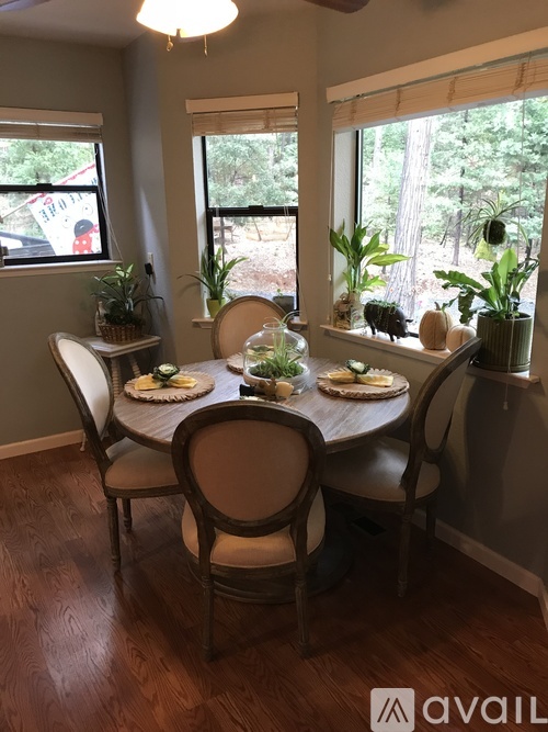 A dining room with a table set for four.