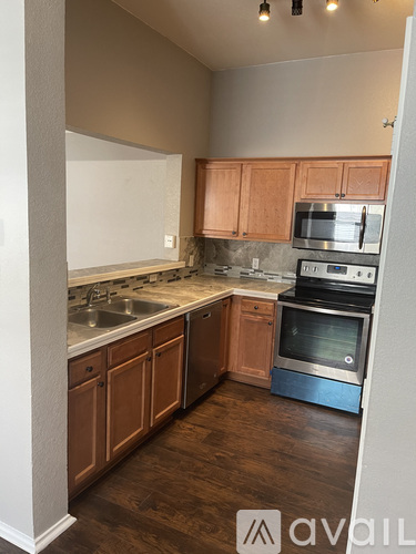 A kitchen with wooden cabinets and stainless steel appliances.