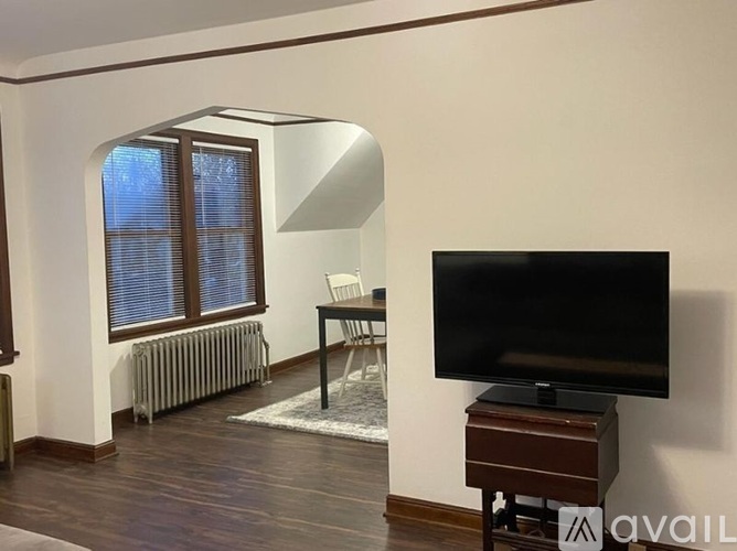 A living room with a television and a chair.