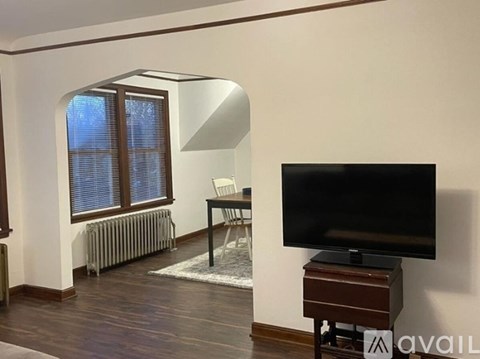 A living room with a television and a chair.