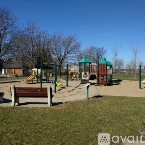 A playground with a slide, swings, and a bench.