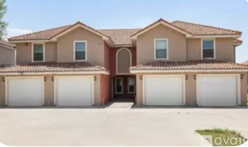 A two-story house with a garage is available for sale.
