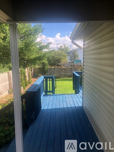 A view from a porch looking out to a backyard.