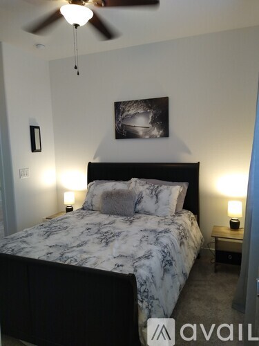 A bedroom with a marble bed and a ceiling fan.