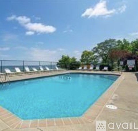 A large outdoor swimming pool surrounded by lounge chairs.