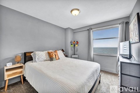 A bedroom with a large bed and a flat screen TV.