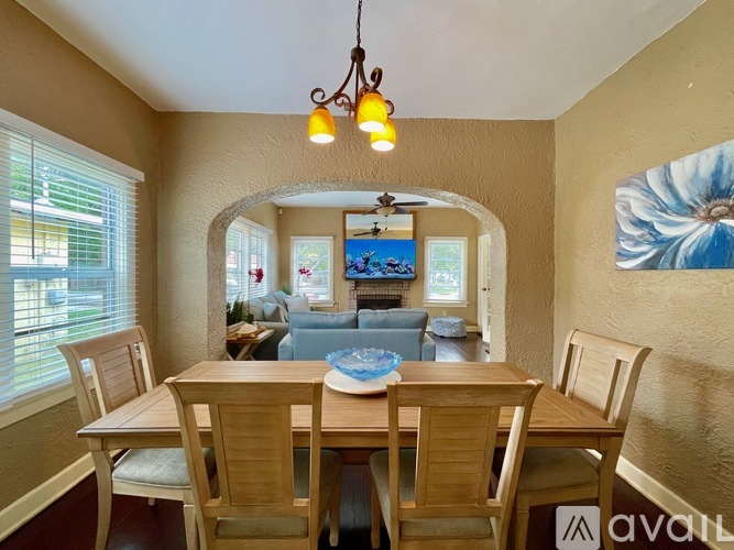 A dining room with a wooden table and chairs.