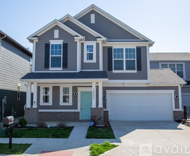 A two-story house with a garage and a blue door.