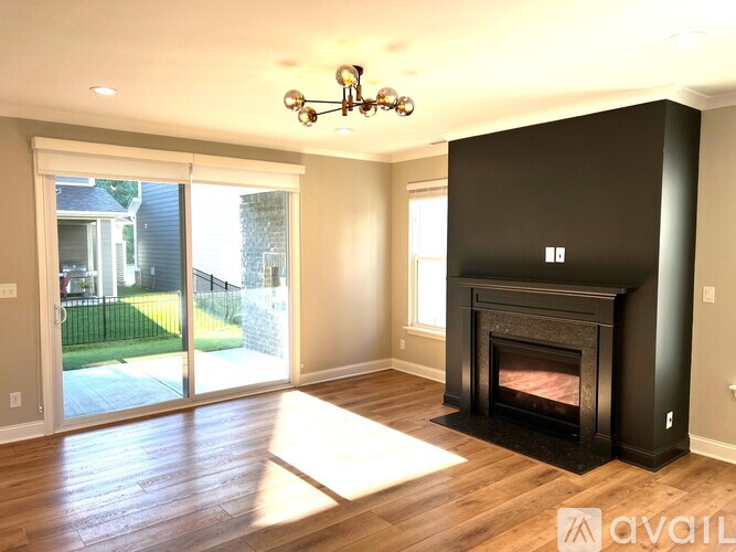 A living room with a fireplace and sliding glass doors.
