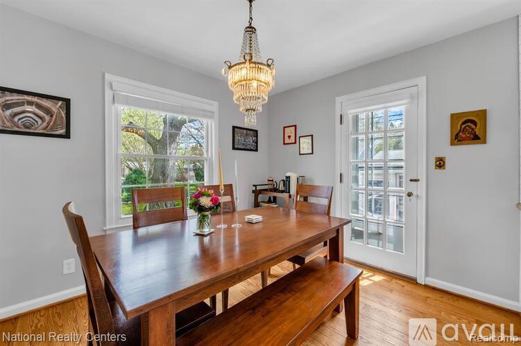 A dining room with a wooden table and chairs.