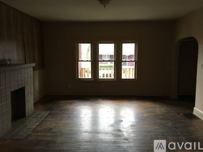 A room with a fireplace and a large window.