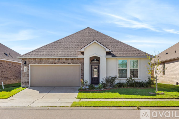 A house with a brown roof and a garage door.