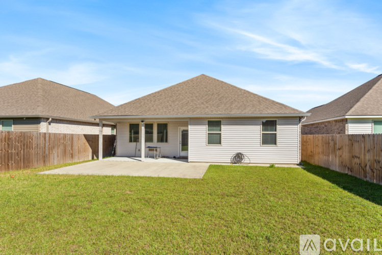 A house with a brown roof and a white exterior is available for sale.