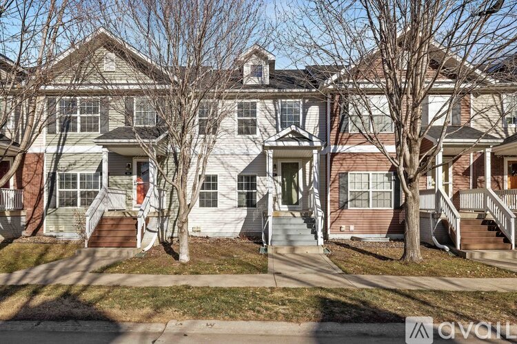 A two-story house with a front porch and a garage.