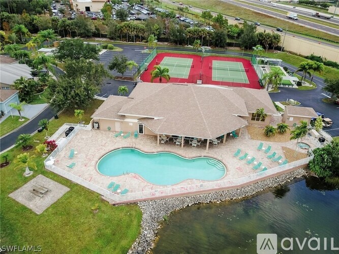 A house with a tennis court and a pool.
