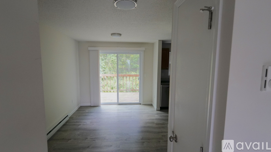 A room with a sliding glass door leading to a balcony.