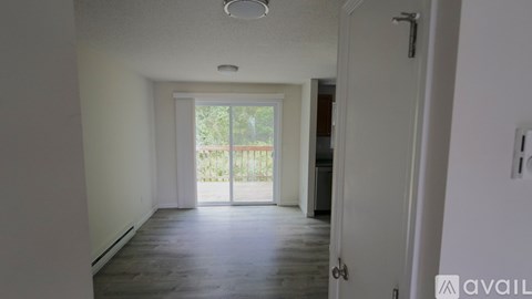 A room with a sliding glass door leading to a balcony.