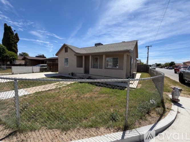 A house with a fence in front of it.