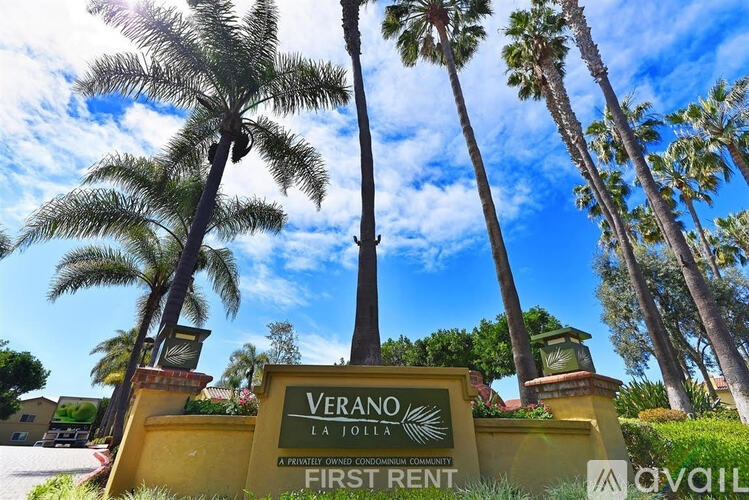 A sign for Verano La Jolla, a private condominium community, is displayed in front of palm trees.