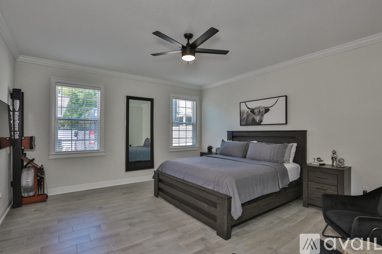 A bedroom with a bed, dresser, and chair.