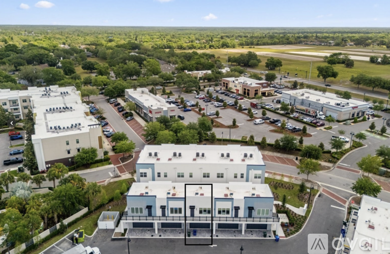 A bird's eye view of a town with a large building in the center.
