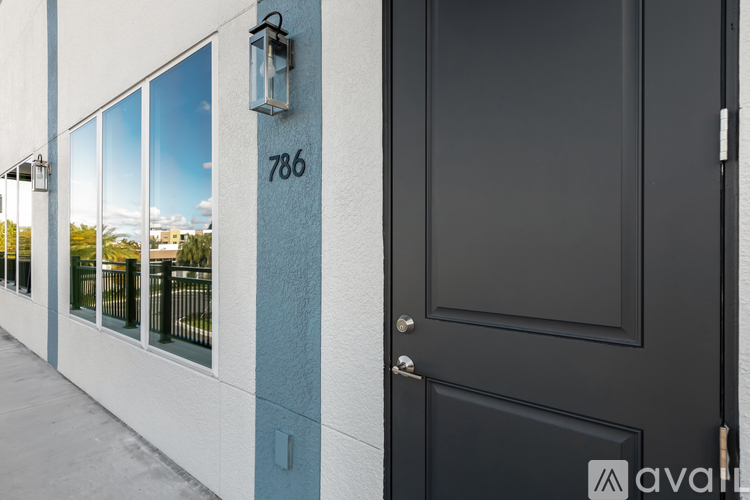 A black door with a number 786 on the wall above it.