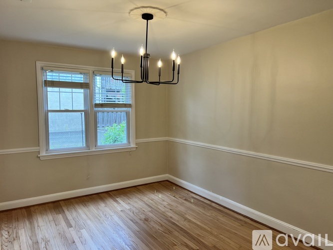 A room with a window and a chandelier.