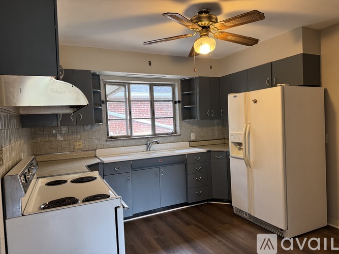 A photo gallery app displaying three images of a kitchen.