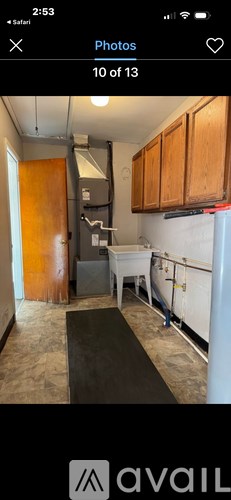 A kitchen with wooden cabinets and a white refrigerator.