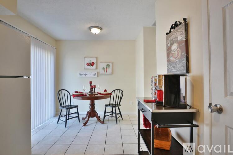 A dining room with a table set for four.