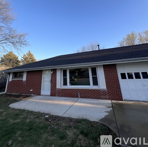 A house with a red brick exterior and a white garage door.
