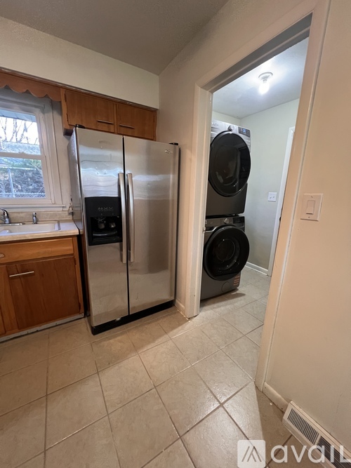 A kitchen with a refrigerator and oven in it.