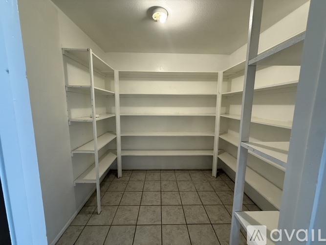 Empty white shelves in a room.