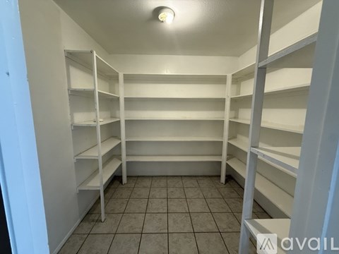 Empty white shelves in a room.