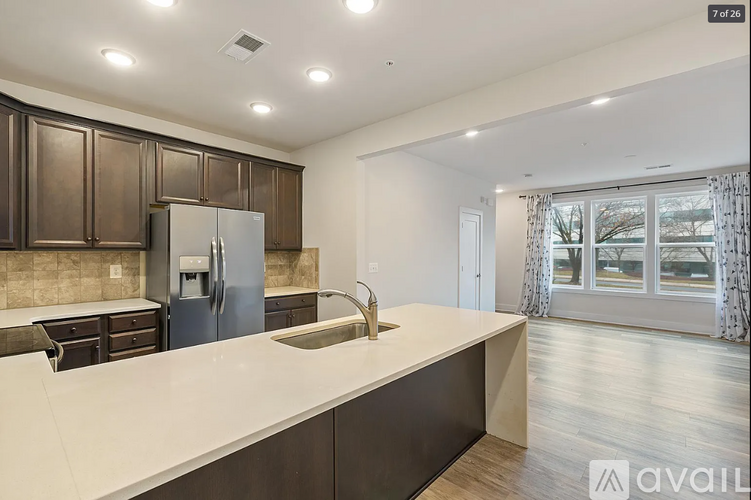 A kitchen with brown cabinets and a white countertop is available for rent.